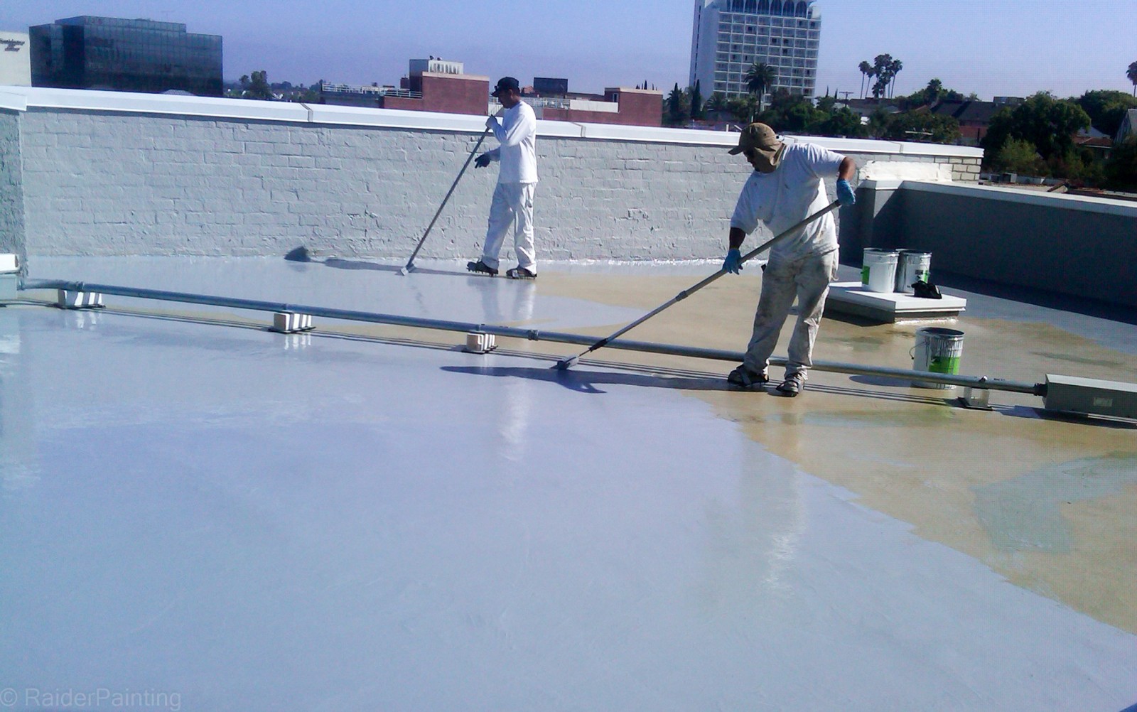 Flat roof waterproofing Queens NY showing coating application on residential rooftop